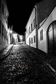 mysterious narrow alley with lanterns in Prague at night

