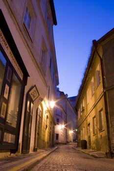 mysterious narrow alley with lanterns in Prague at night

