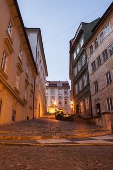 mysterious narrow alley with lanterns in Prague at night

