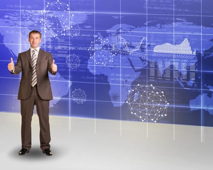 Businessman showing ok on abstract background with world map and graphs