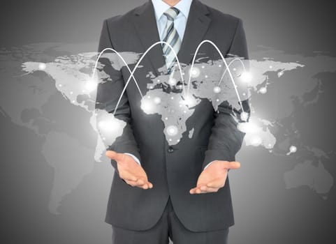 Businessman with world map in hands on abstract blue background