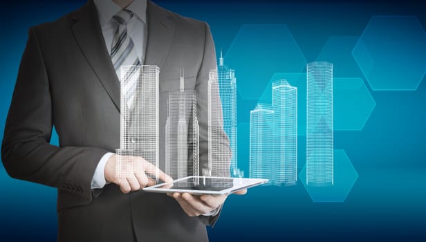 Businessman using tablet with 3d model of city on abstract blue background