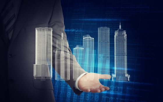 Businessman with 3d model of city in hands on abstract blue background with numbers