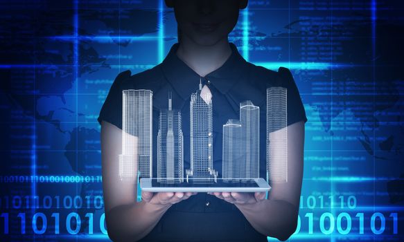 Businesswoman holding tablet and 3d city model on abstract blue background