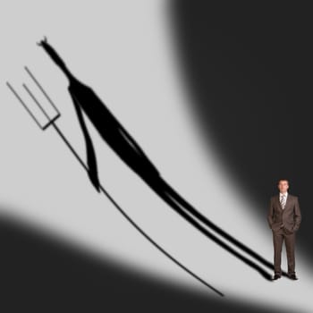 Businessman with demon shadow on gray wall background