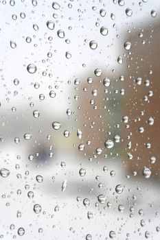 On a winter raining day. Drops of water on the window. Shallow DOF 