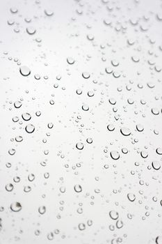 Drops of rain on the inclined window, shallow dof