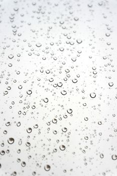 Drops of rain on the inclined window, shallow dof