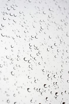 Drops of rain on the inclined window, shallow dof