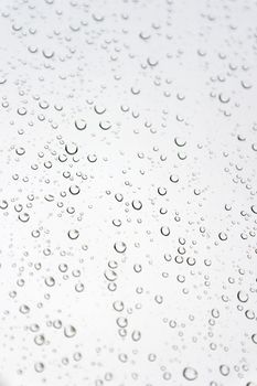 Drops of rain on the inclined window, shallow dof