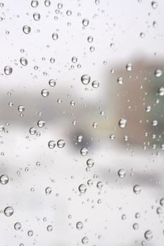 On a winter raining day. Drops of water on the window. Shallow DOF