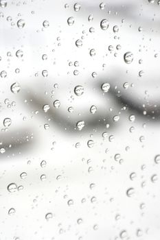 On a winter raining day. Drops of water on the window. Shallow DOF