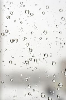 On a winter raining day. Drops of water on the window. Shallow DOF