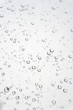 Drops of rain on the inclined window, shallow dof
