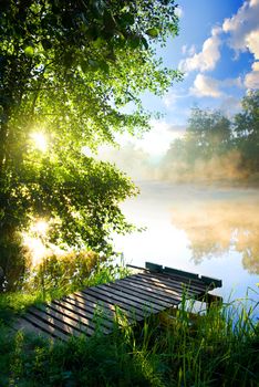 Fishing pier on river in the morning