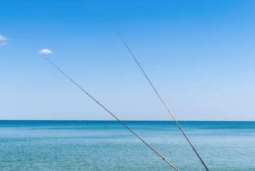 Fishing rods on the background of blue water