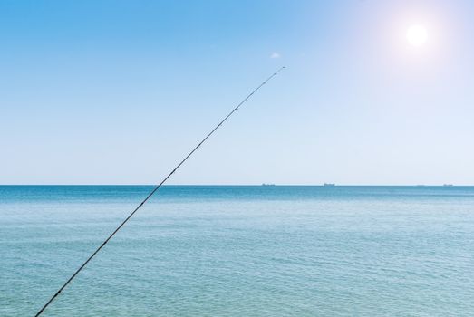 Fishing rods on the background of blue water