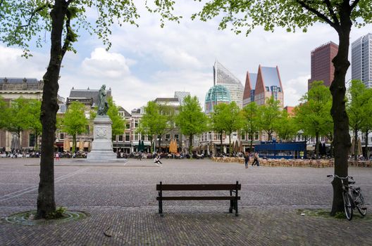The Hague, Netherlands - May 8, 2015: People at Het Plein in center of The Hague, with the statue of William the Silent in the middle. on May 8, 2015.