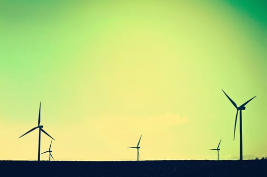 Shadows of windmills on the field. Vintage instagram picture. Alternative energy.