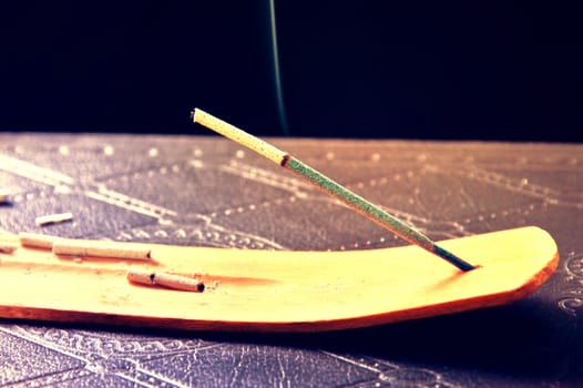 Smoking incense stick for aromather. Vintage instagram picture.