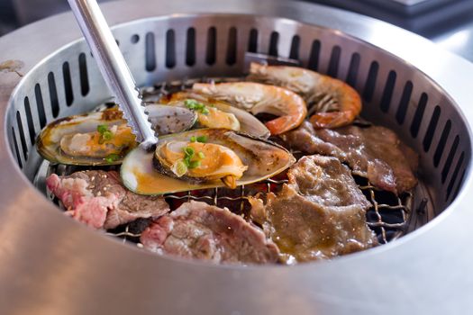 Mixed Roasted Meat and Seafood on the BBQ Grill on roast.