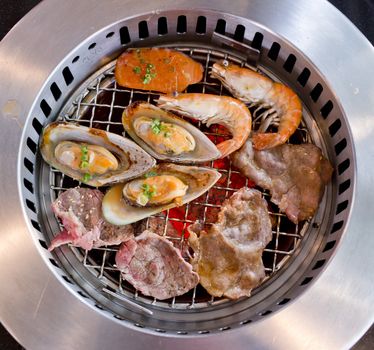 Mixed Roasted Meat and Seafood on the BBQ Grill on roast.