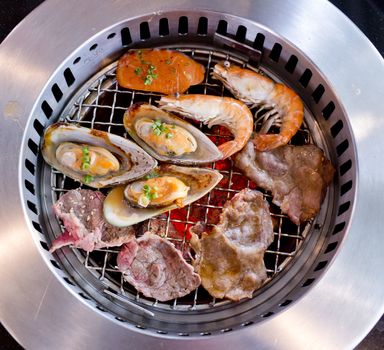 Mixed Roasted Meat and Seafood on the BBQ Grill on roast.