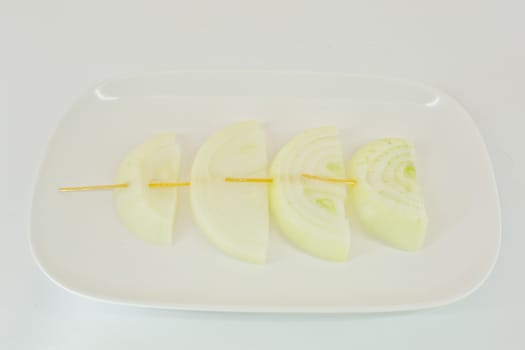 Skewers with fresh onions on the white plate - isolated