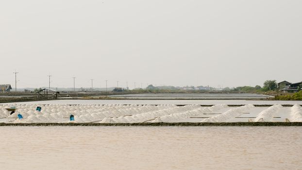 Salt mountain in salt pan on Thailand.