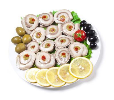 fish slices served with tomato and olives