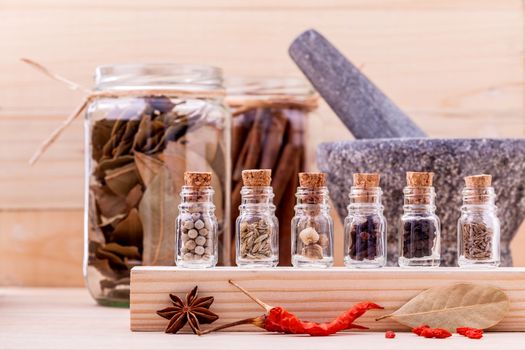 Assortment of Thai food Cooking ingredients in glass bottles on wooden background.