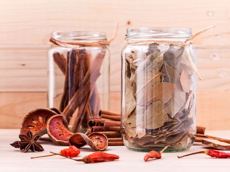 Assortment of Thai food Cooking ingredients in glass bottles on wooden background.