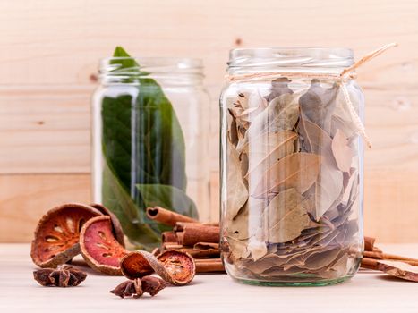 Assortment of Thai food Cooking ingredients in glass bottles on wooden background.