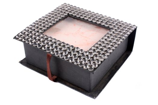 A custom made jewelery box decorated with beads, on white studio background.