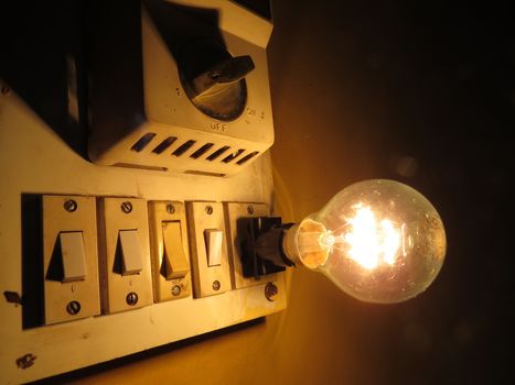 An old switchboard with fan regulator and tungsten bulb.                               