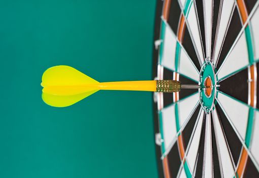 Dart sticks to bullseye on a dart board