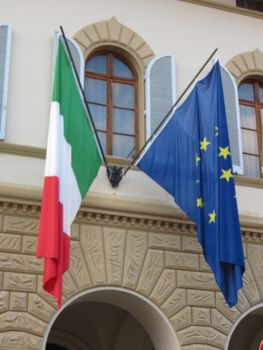 The national flag of Italy and the flag of the European Union