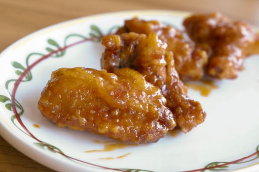 crispy fried chicken with sweet sauce on white plate