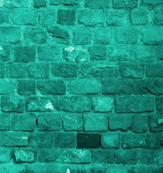 Background of Turquoise Old Damaged Bricks with Concrete Smoothing closeup