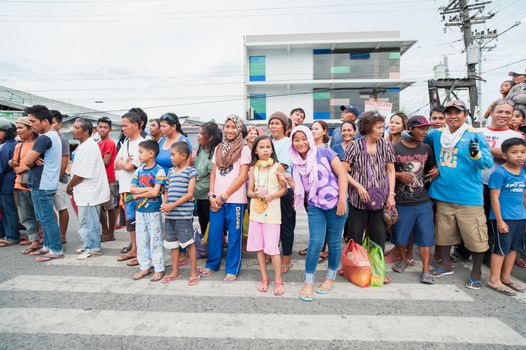 General Santos City, The Philippines - September 1, 2015: Spectators waiting for the parade on the opening day of the 17th Annual Gensan Tuna Festival to celebrate the  most important industry of city, the tuna canneries.