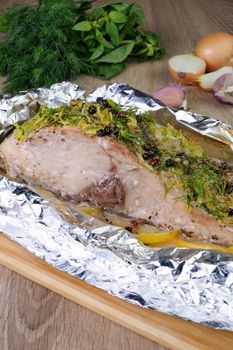 Baked carp in a piece of lemon marinade in foi