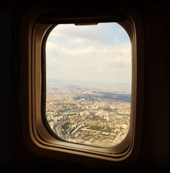 View over Paris from the aircraft window. Airplane approaching the city.