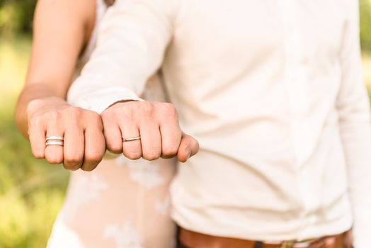 the bride and groom to hold hands, wedding rings