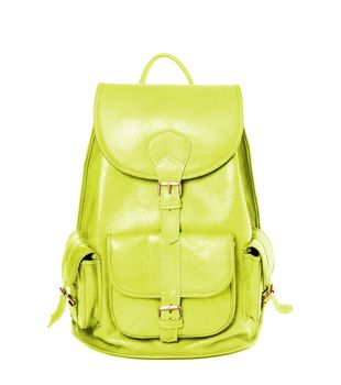 Yellow leather backpack standing isolated on white background