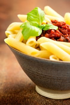 Penne pasta with a tomato bolognese beef sauce on the table