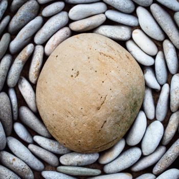 Lot of pebbles around big stone