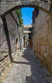 Typical street in the old town of Rhodes in Greece showing medieval type streets and architecture