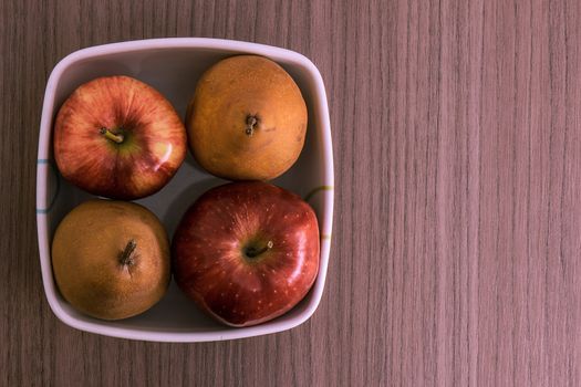 Bowl of red apples and golden pears
