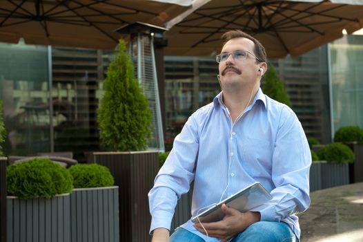 Man using tablet computer with high spees internet outdoors