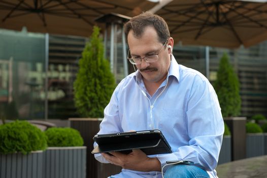 Man using tablet computer with high spees internet outdoors